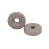 Two circular samarium cobalt magnets, the patterns of the magnets themselves can be clearly seen