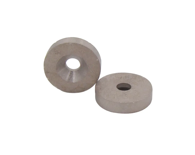 Two circular samarium cobalt magnets, the patterns of the magnets themselves can be clearly seen