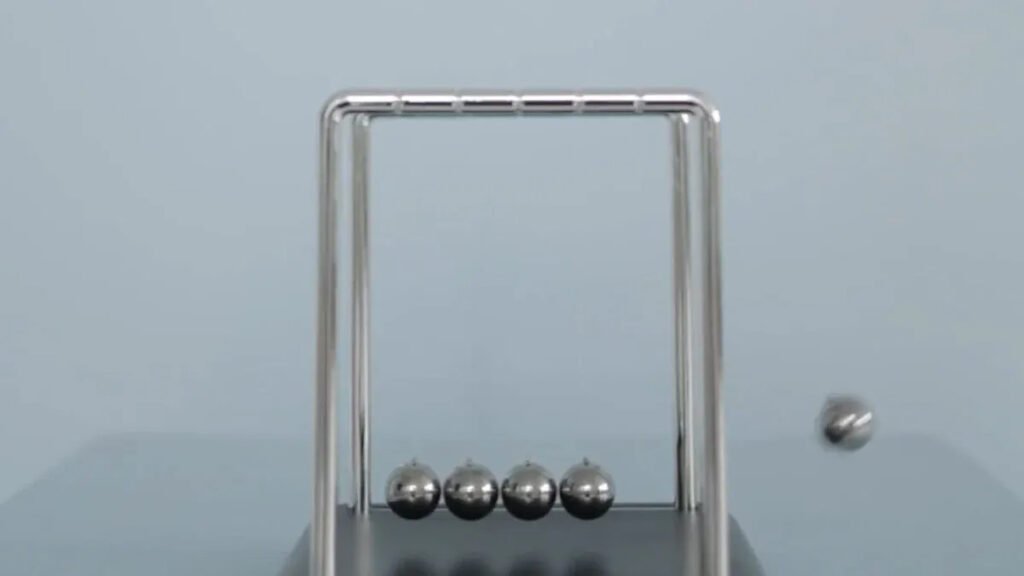 Newton's cradle in motion, illustrating principles related to Industrial Neodymium Magnets.