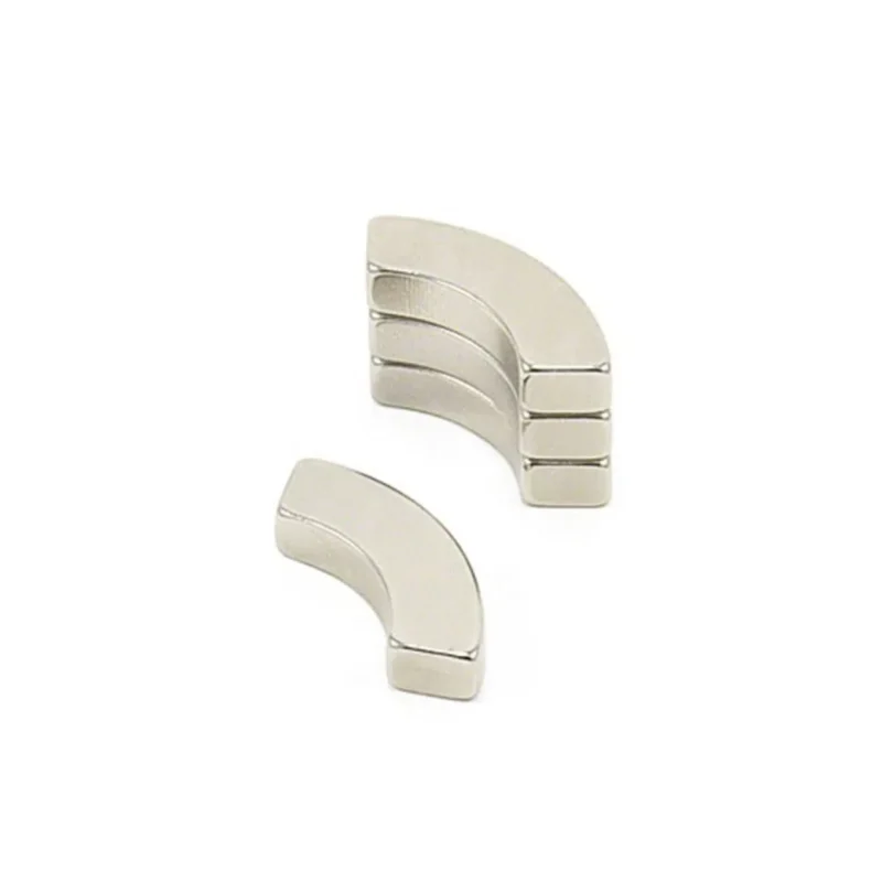 Stacked small neodymium magnets in arc shape, customized grade, for industrial magnet applications.