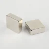 Pair of N52 neodymium magnets (square blocks, 10×10×10mm, nickel - plated) showcasing shape and finish.