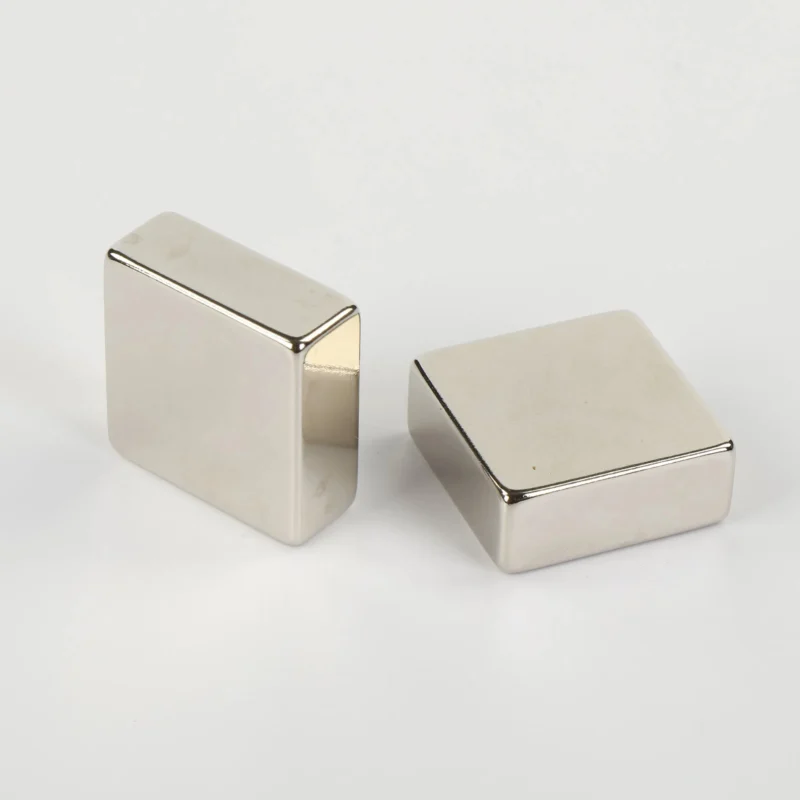Pair of N52 neodymium magnets (square blocks, 10×10×10mm, nickel - plated) showcasing shape and finish.