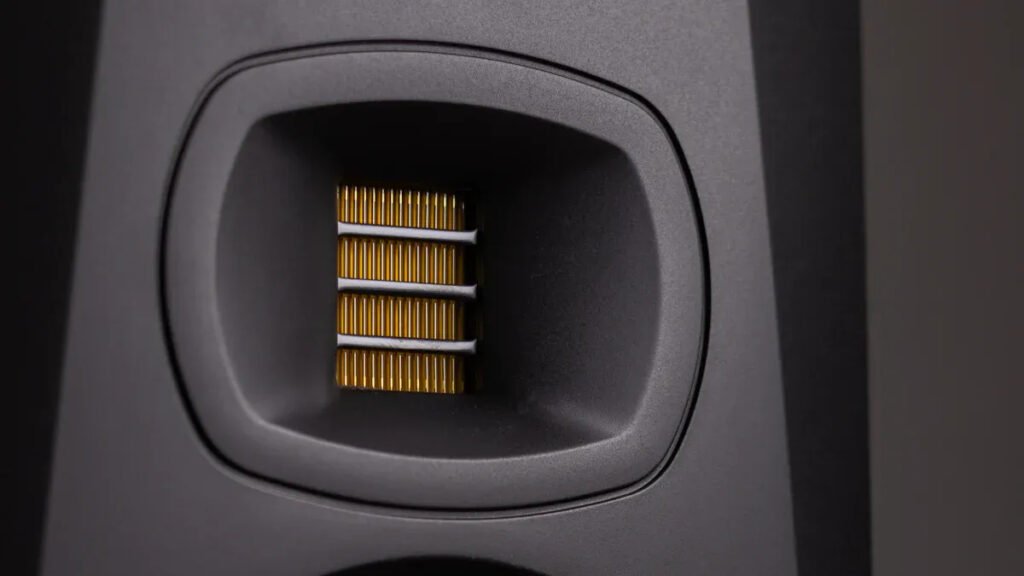 Close - up of the internal port of a speaker using alnico magnet, revealing golden components related to the alnico magnet structure.