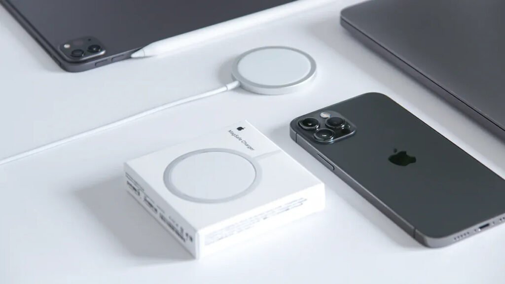 Apple devices (iPhone, iPad, Apple Pencil) with a MagSafe charger and its packaging, demonstrating Magnetic Charger compatibility.