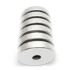 Stack of round N42 neodymium magnets showcasing magnetic attraction in industrial setup