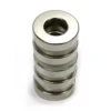 Closeup of single tiny neodymium magnet ring, highlighting Ni - Cu - Ni coating and +/-0.05mm tolerance for precision applications.