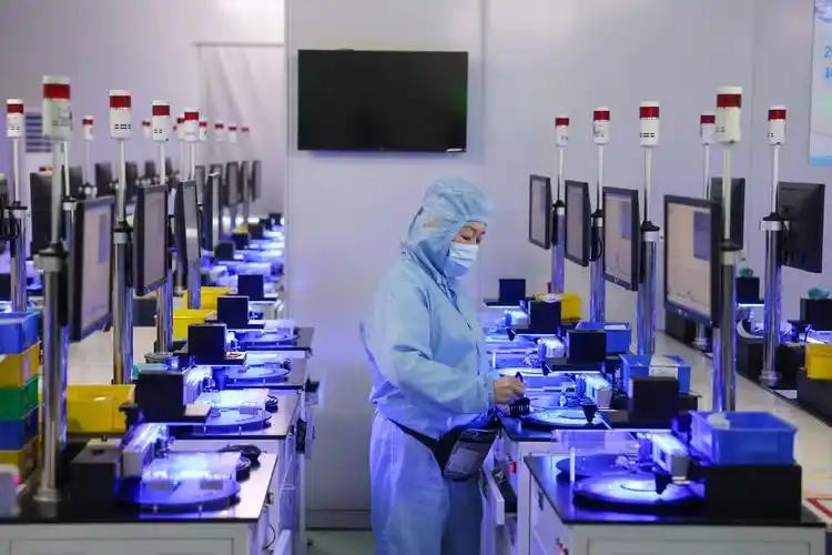 Alnico magnets production workshop - worker operating precision testing equipment in clean room environment